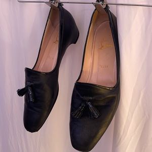 Louboutin black leather tasseled loafers. Small heel.
